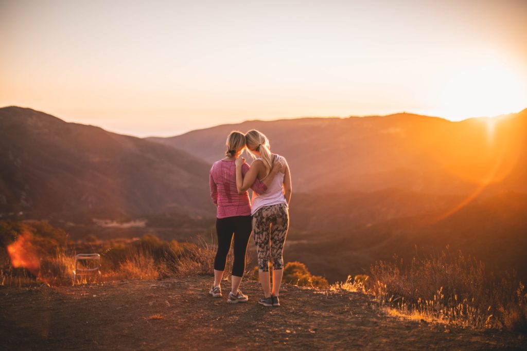 Image of two women shoulder to shoulder looking down at a valley. Are you looking for a weight loss program? Wanting an immune system boost? Our functional medicine doctor can help with shape reclaimed in the Chicago area.