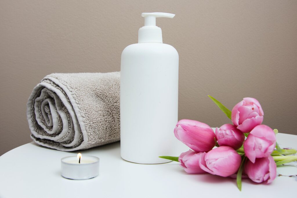 Image of a lotion bottle, towel, candle, & pink flowers. Have you been searching for "massage therapy near me"? Our massage therapist can help. We even offer post natal massage and prenatal massage in Orland Park, IL 60465. 