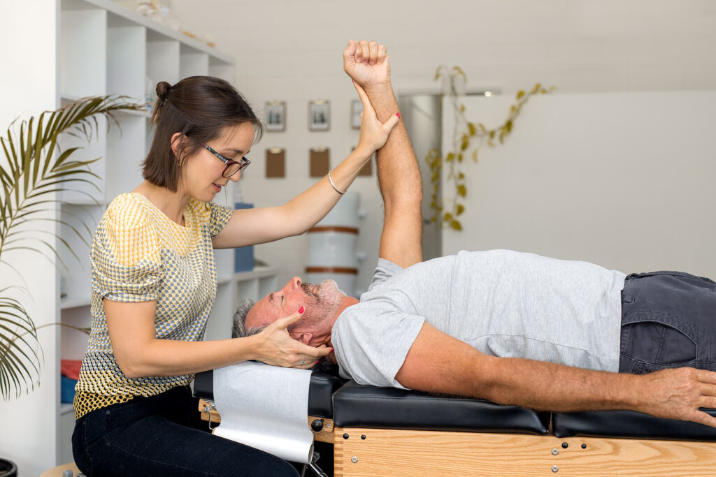 Image of a female chiropractor adjusting a mans neck and arm. Don't suffer with pain, weight gain, or chronic disease alone. You can start to feel better with chiropractic care in Orland Park, IL 60477. If you are ready to restore your health then we are ready to help. Call today to speak with a holistic chiropractor in the Chicago area 60423.