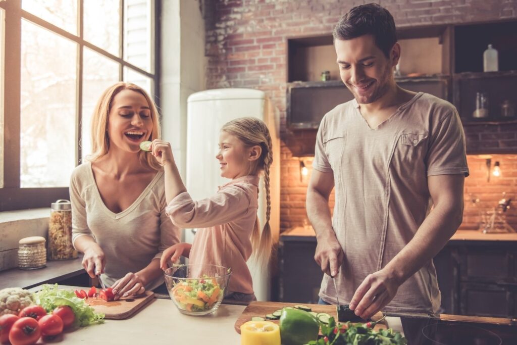 A family of three smiles while chopping vegetables in the kitchen. Learn how Shape Reclaimed in the Chicago area can offer support by contacting a holistic doctor in Orland Park, IL today. Search for an immune system boost Orland Park, IL today.
