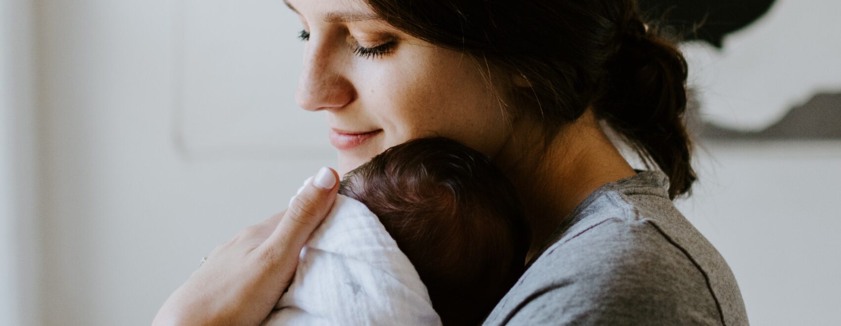 Image of a mom soon after birth holding her baby. Have you recently had a baby and looking for "massage therapy near me"? If so you could benefit from getting a post natal massage in Orland Park, IL 60423. Reach out and schedule your postpartum massage at our Orland Park, IL office. Call today!