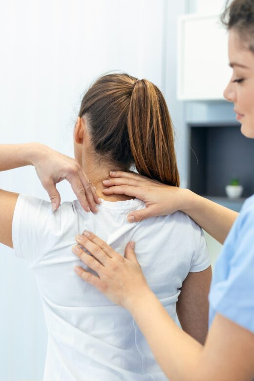 Image of a Chiropractor in Orland Park assessing a patients back. Showing what you can expect when you can expect from seeing a holistic chiropractor for chiropractic care in Orland Park or the Chicago area.
