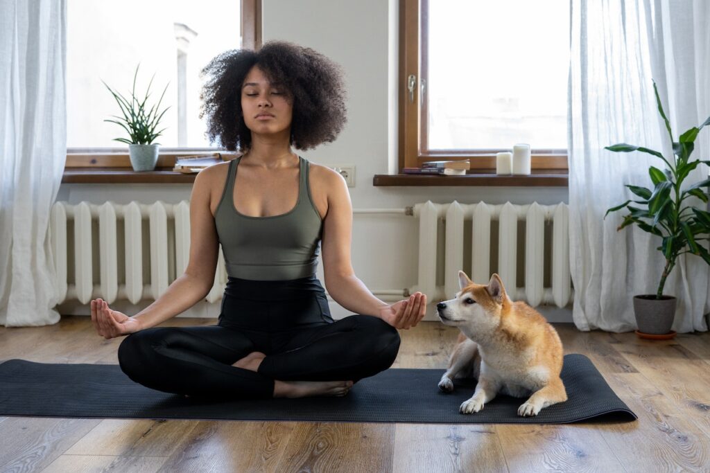 A woman meditates while sitting next to her dog. Learn how functional medicine in Orland Park, IL can offer support with removing stressors. Contact a functional medicine doctor in Orland Park, IL, or search “what is functional medicine chicago area” to learn more.

