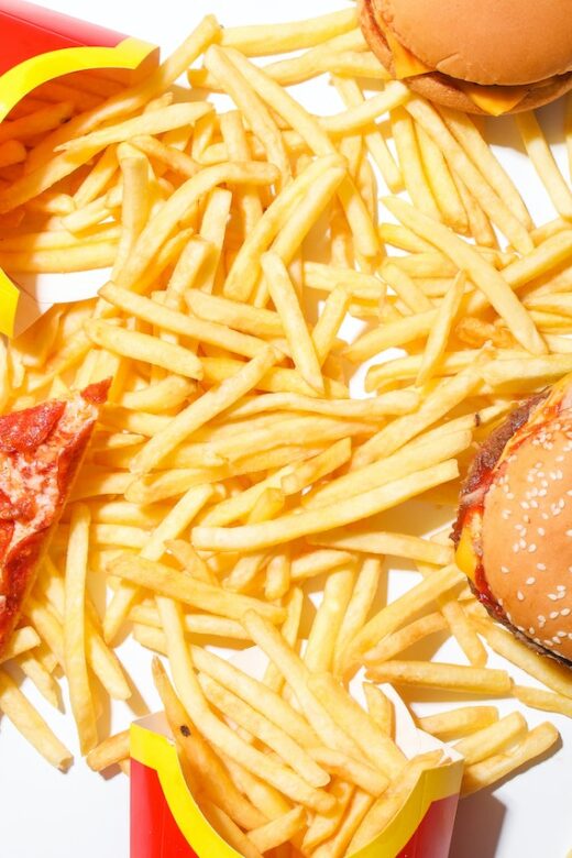 A top down view of a pile of fries, pizza, and burgers. This could represent the American diet that a functional medicine doctor in the Chicago area can help you change. Learn more by searching for diabetes functional medicine in orland park, il, or “genetic health testing in the chicago area”.