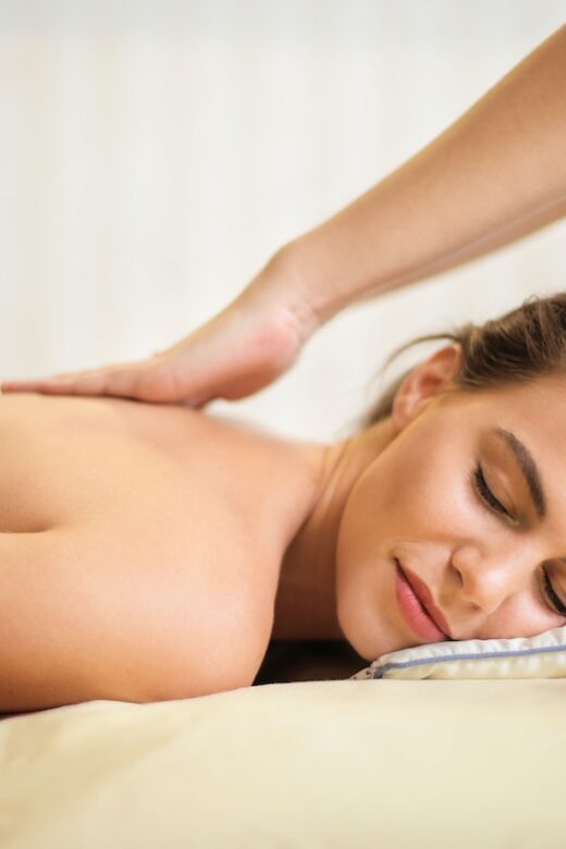A woman lays down smiling while receiving a back massage. This could represent the benefits of massage therapy in Orland Park, IL for chronic pain. Learn more about the support a therapeutic massage in Orland Park, IL can offer today.