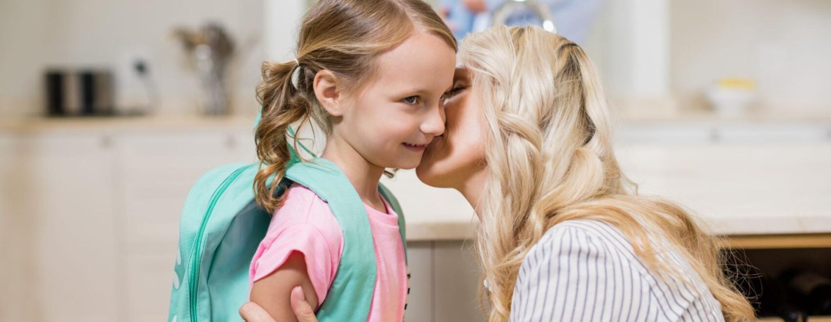 A mother kisses her daughter on the cheek. Learn how chiropractic care in Orland Park, IL can offer support by searching for "chiropractor orland park" today. Chiropractic care for sciatica in orland park, IL can help your child and the new school year.