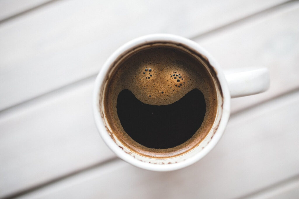 A cup of coffee that appears to be smiling. Learn more about the support a functional medicine doctor in the Chicago area can offer. Search for what is functional medicine Chicago area today.
