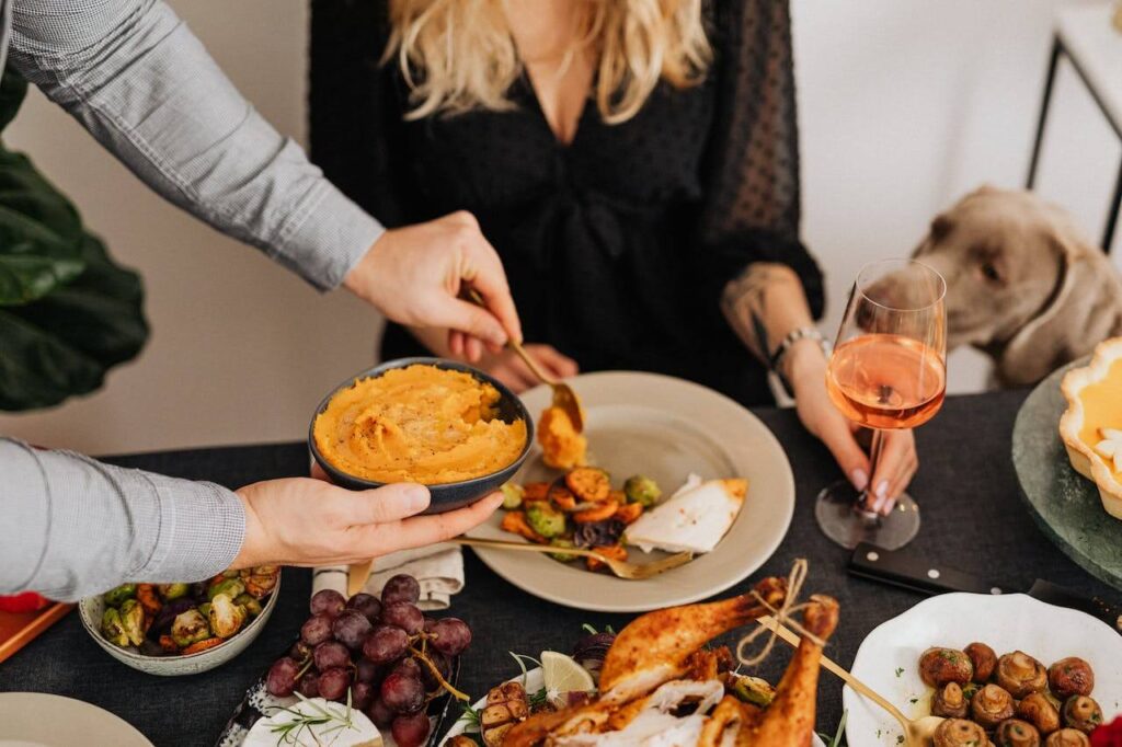 A close up of a family serving food around a dinner table. Learn how a holistic doctor in Orland Park, IL can offer support during the holidays by searching for genetic health testing in the Chicago area. Search for a functional medicine doctor in the Chicago area. 
