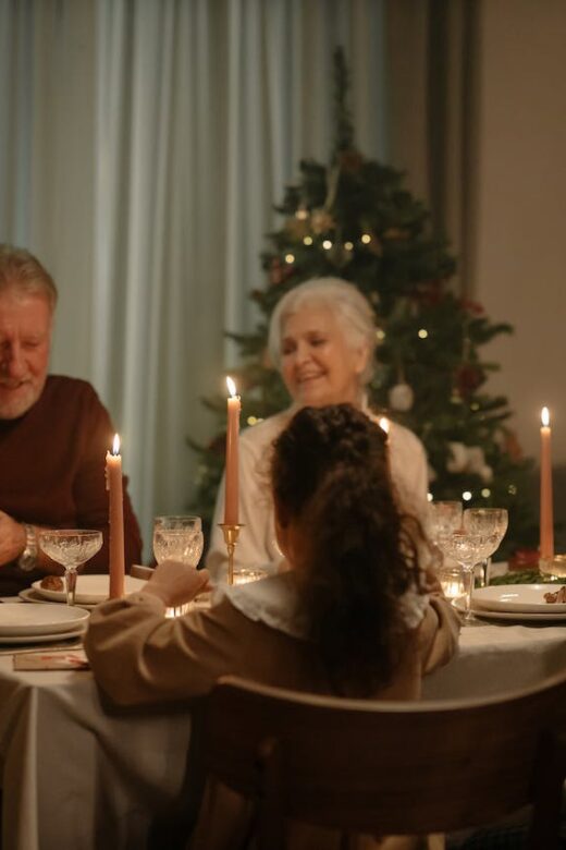 A family smiles while sitting around a dinner table. This could represent bonding during the holidays. Learn how a holistic doctor in Orland Park, IL can offer support with genetic health testing in the Chicago area and more.