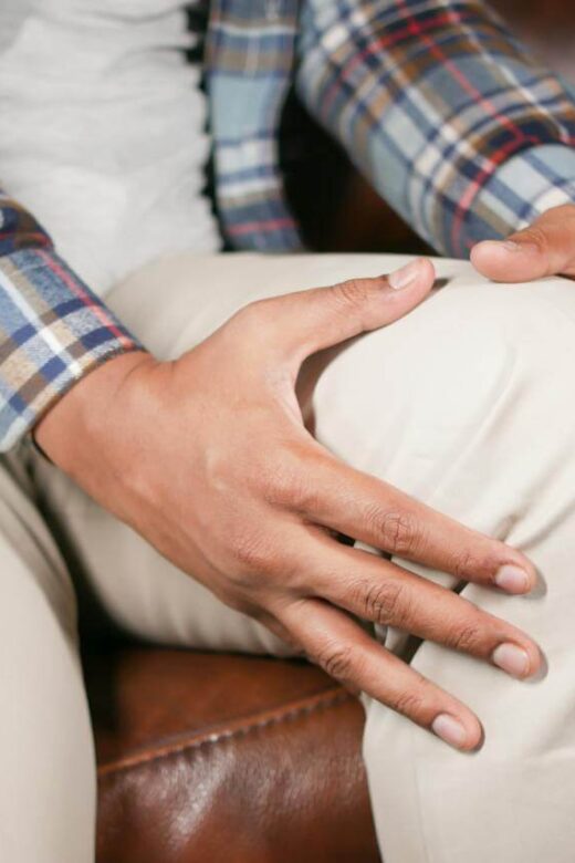 A close up of a person holding their knee in pain. This could symbolize the pain that chiropractic care in Orland Park, IL can address. Learn more about the benefits of chiropractic care for sciatica in Orland Park, IL and more by contacting a holistic chiropractic in the chicago area.