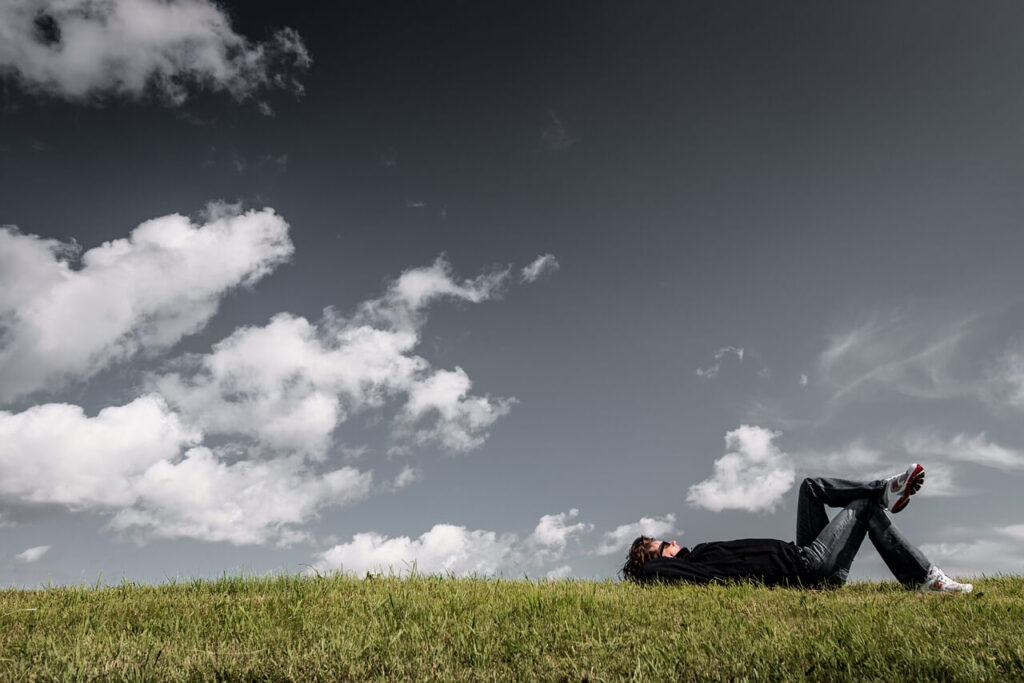 A man lays in a field with legs crossed and arms behind their head. This could represent the benefits of being outdoors that a holistic doctor in Orland Park, IL can help you realize. Learn more about the benefits of chiropractic care in Orland Park, IL and how a holistic massage in Orland Park, IL can offer support. 
