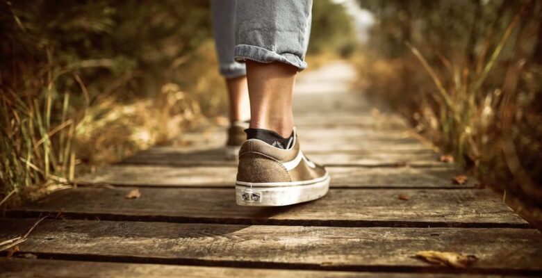A close up of a person walking on a wooden path. This could represent how exercise can help improve blood sugar levels. Learn more about Shape Reclaimed in the Chicago Area and how a holistic doctor in Orland Park, IL can offer support. Search for diabetes functional medicine in Chicago, IL today.