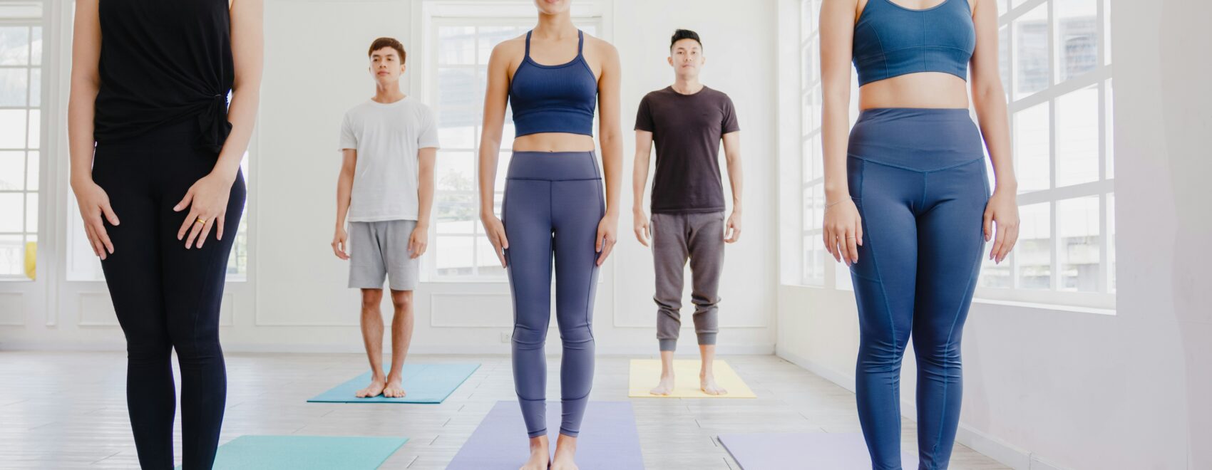 A group of people standing for a yoga class. Learn how a holistic chiropractor in the Chicago area can offer support with improving posture. Search for Chiropractor Orland Park to learn more about a holistic doctor in Orland Park, IL can offer support.