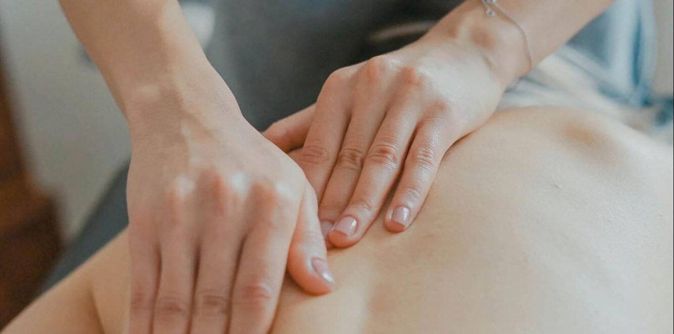 A close up of a massage therapist in Orland Park, IL working out a knot in the shoulder of a client. Learn how a marriage therapist in Orland Park, IL can offer support with a therapeutic massage in Orland Park, IL. Learn more about the benefits of a holistic massage in Orland Park, IL.