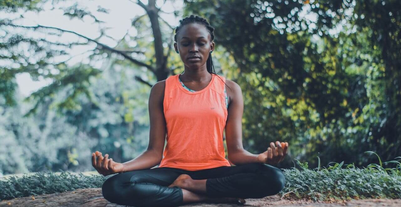 A black woman sits outside while meditating with legs crossed. Learn how holistic medicine in the Chicago area can offer support with vagus nerve issues. Contact a holistic doctor in Orland Park, IL for more info on how a holistic massage in Orland Park, IL can help.