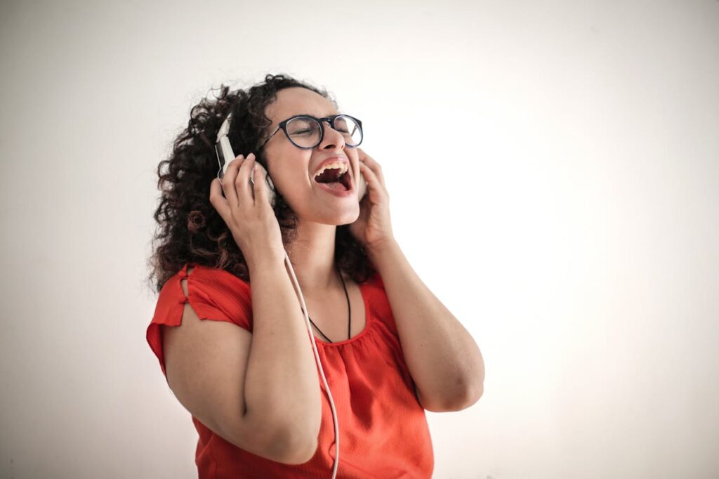 A woman wearing headphones sings with a happy expression. This could represent the support that singing can offer in stimulating your vagus nerve. Learn more about holistic medicine in the Chicago area by contacting a holistic doctor in Orland Park, IL. They can offer a holistic massage in Orland Park, IL and other forms of support.
