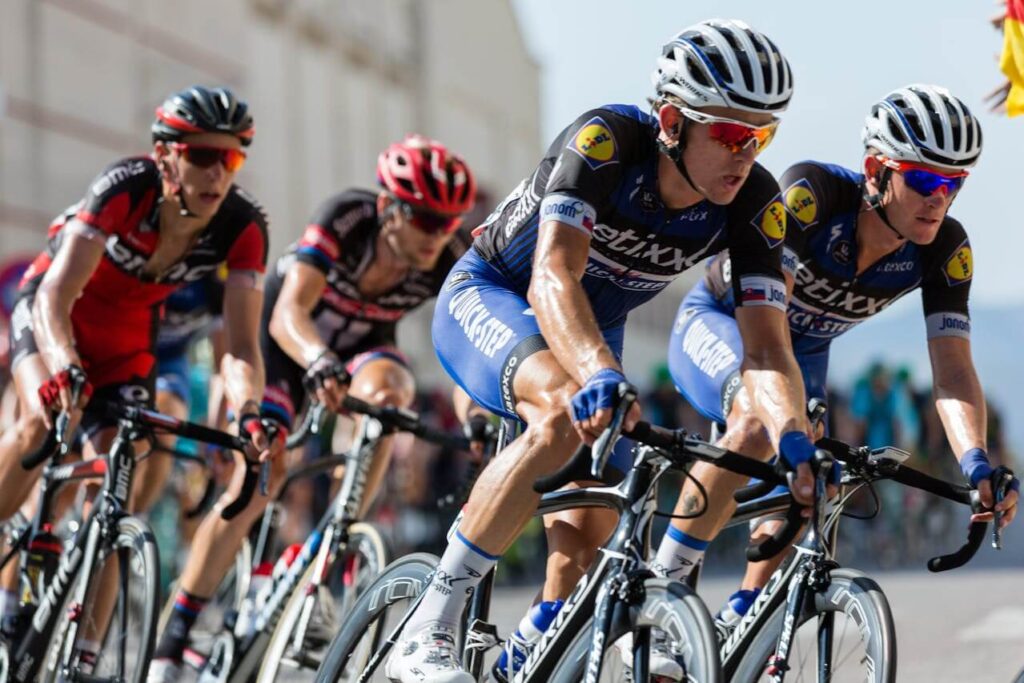 A crowd of bike riders round a corner while breathing heavily. Learn more about chiropractic care in Orland Park, IL and how a Chiropractor Orland Park can offer support. Search for a holistic chiropractor in the Chicago area today.
