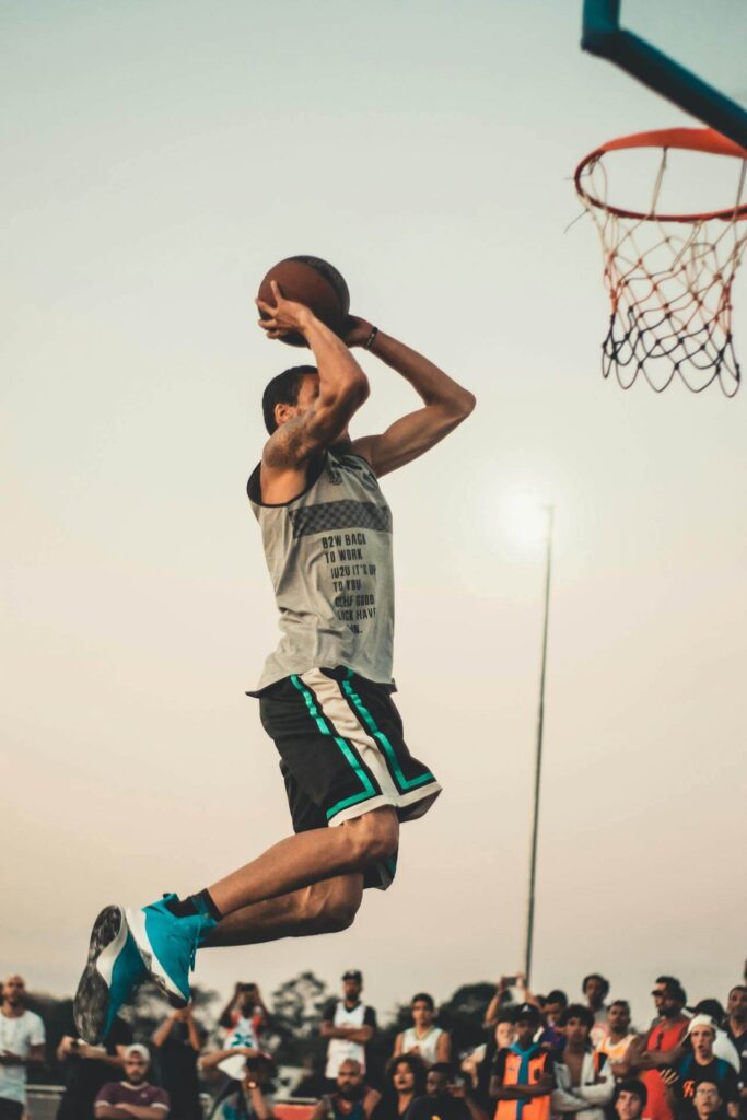 A man jumps toward a basketball hoop while in the middle of a layup. Learn how chiropractic care in Orland Park, IL can offer support by searching for a holistic chiropractor in the Chicago area. They can offer chiropractic care for sciatica in Orland Park, IL and more.
