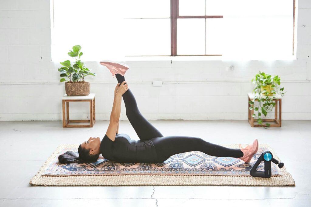 A woman lays on her back while stretching on a floor mat. This could represent the importance of prep to avoid injuries, and how chiropractic care in Orland Park, IL can offer support. Search for a holistic chiropractor in the Chicago area to learn more about how a chiropractor for sciatica in orland park, il can help.
