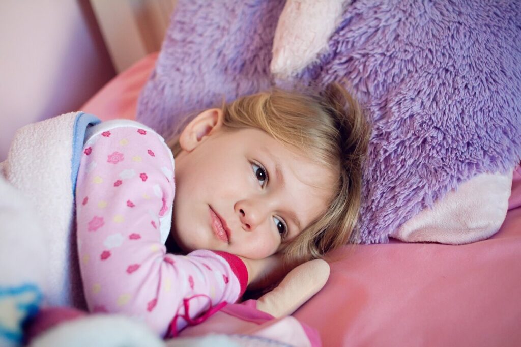 A child lays in bed with a tired expression. This could represent back to school stress that a massage therapist in Orland Park, IL can help you address. Learn more about a holistic massage in Orland Park, IL by searching for massage therapy in Orland Park, IL today.
