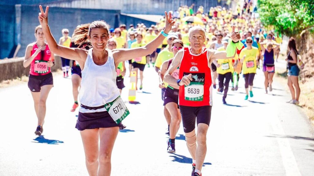 A woman holds up peace signs while in front of a crowd of people running in a marathon. Learn how chiropractic care in Orland Park, IL can offer support by searching for a holistic chiropractor in the Chicago area. They can offer chiropractic care for sciatica in Orland Park, IL and more.
