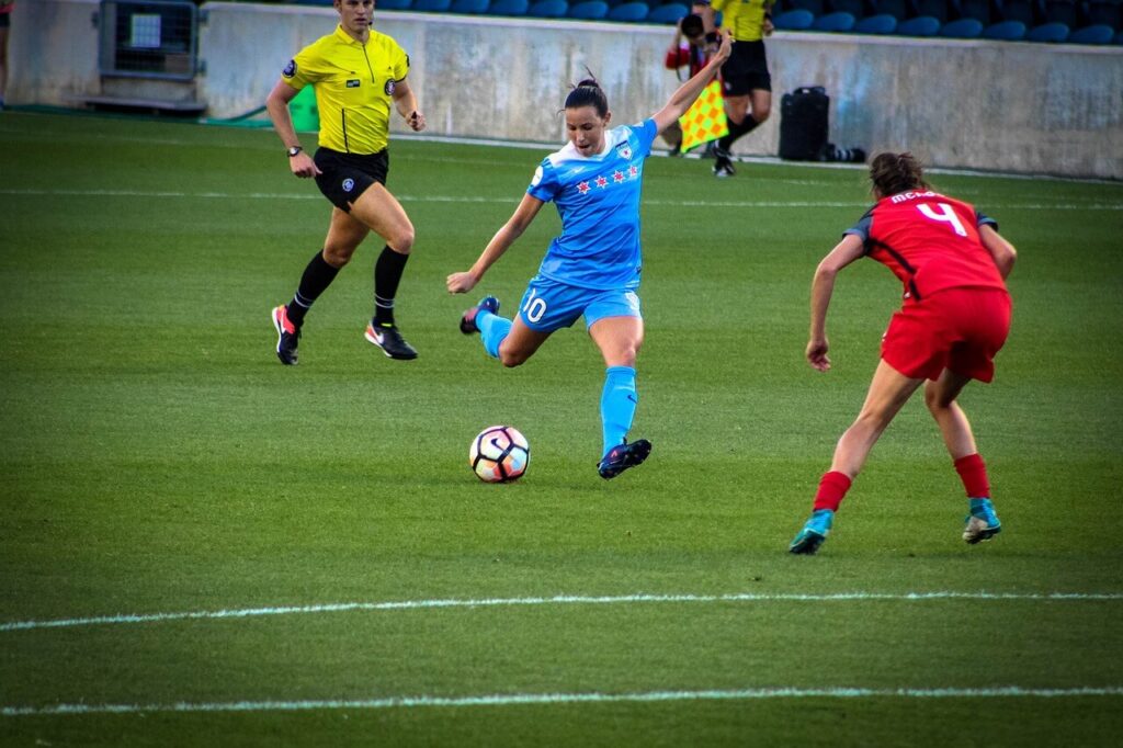 A woman kicks a soccer ball as another person tries to block her. This could represent the importance of performing well in sports, and how chiropractic care in Orland Park, IL can offer support. Search for a holistic chiropractor in the Chicago area to learn more.
