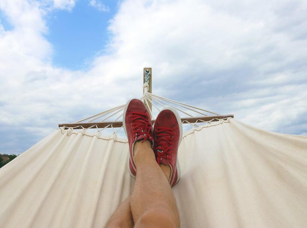 A close up of a person laying in a hammock with their legs crossed. This could  represent the importance of addressing stress with a holistic doctor in Orland Park, IL. Learn more about holistic acupuncture in Orland Park, IL and other serivces like chiropractic care in Orland Park, IL. 
