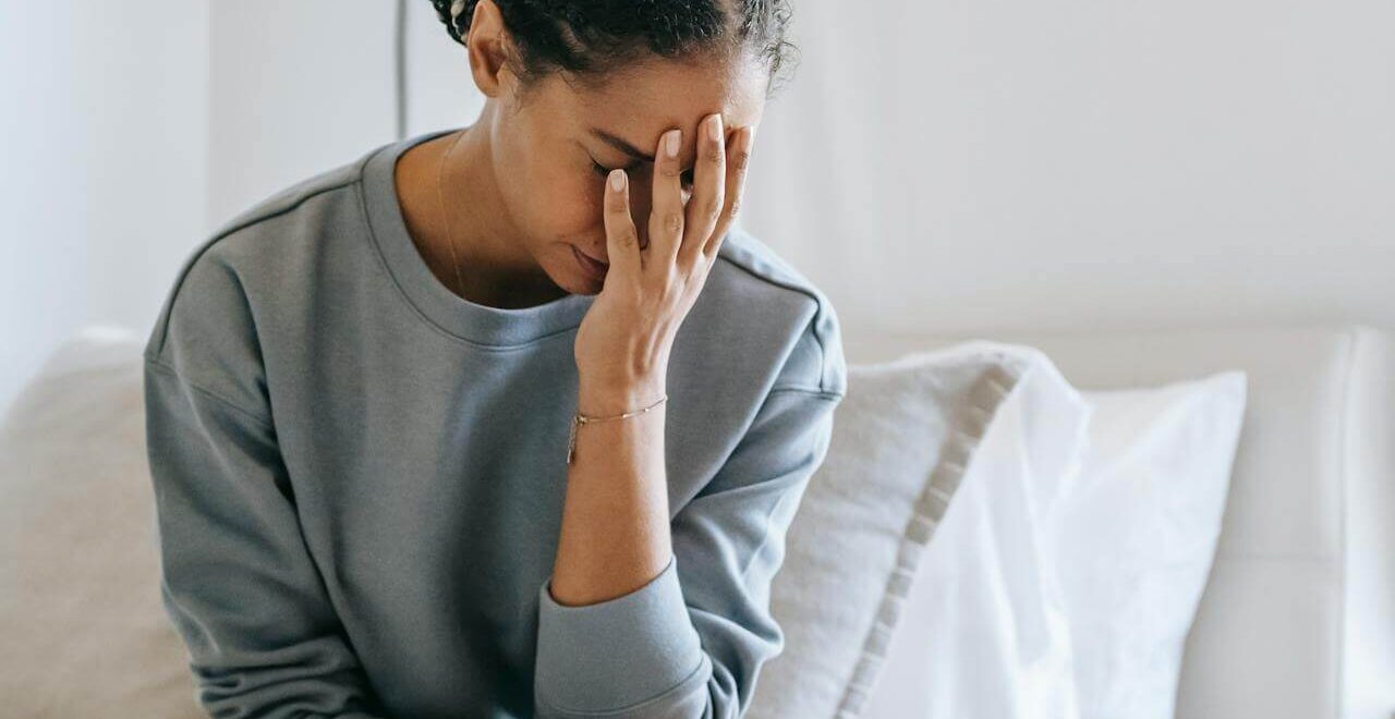 A woman with a pained expression touches her face with her hand. This could represent the pain of POTS that functional medicine in Orland Park, IL can address. Learn more about how a functional medicine doctor in the Chicago area can offer support. Search for holistic medicine in the Chicago area to learn more today.