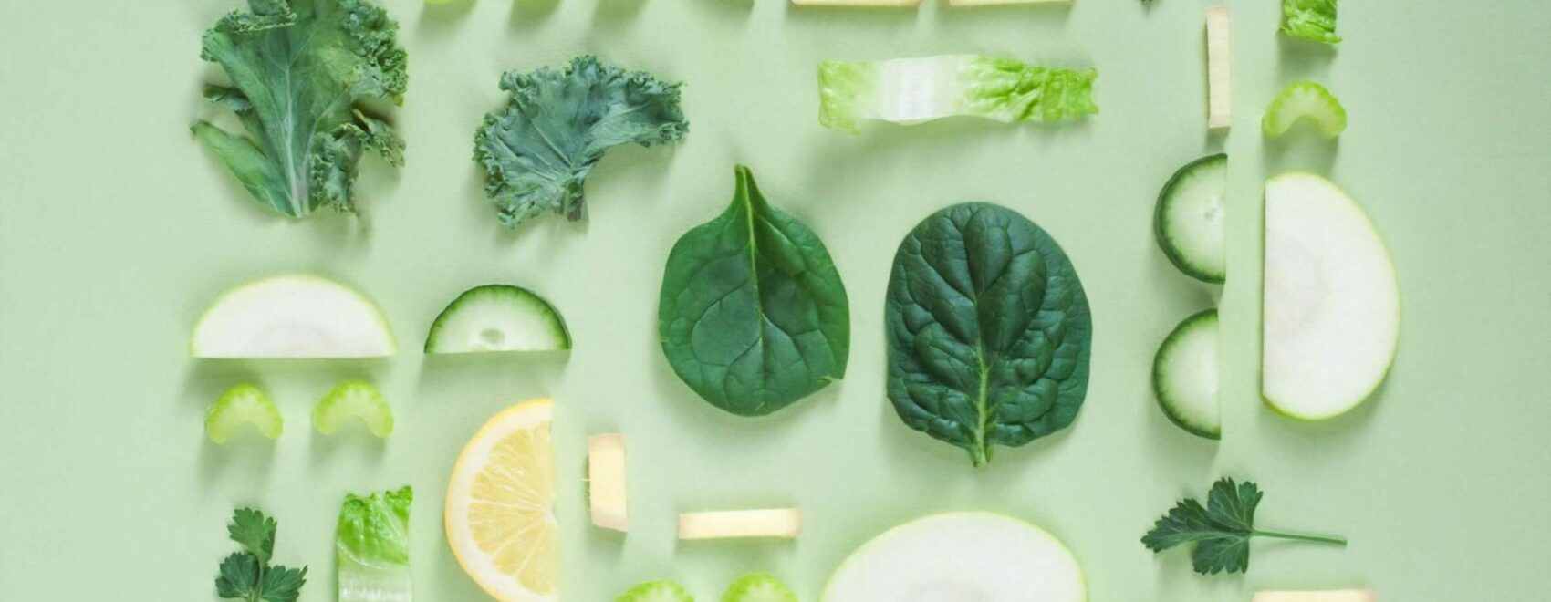 A top down view of various green foods inluing parsley, lettuce, spinach, and more. Learn more about how a holistic doctor in Orland Park, IL can offer support by searching for holistic acupuncture Orland Park, IL today.