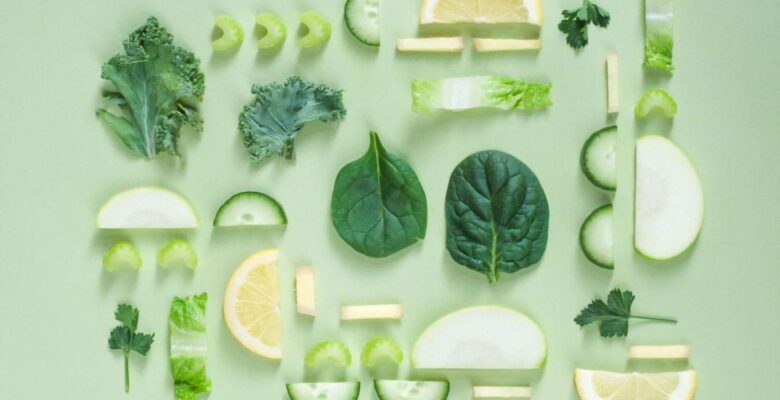 A top down view of various green foods inluing parsley, lettuce, spinach, and more. Learn more about how a holistic doctor in Orland Park, IL can offer support by searching for holistic acupuncture Orland Park, IL today.