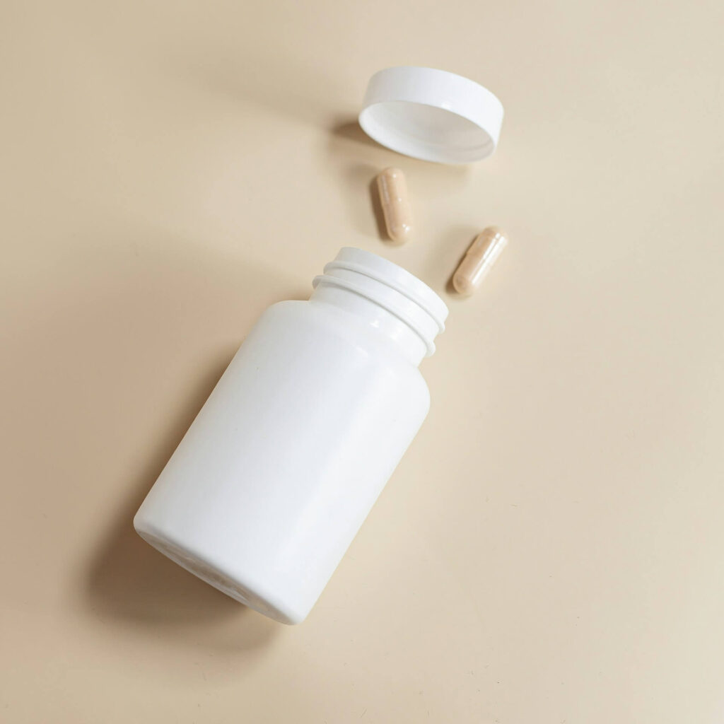 A close up of a bottle of supplements, representing a helpful way to support health in holistic ways. Contact a holistic doctor in Orland Park, IL by searching for a holistic massage in Orland Park, IL. They can offer chiropractic care and other servces.  
