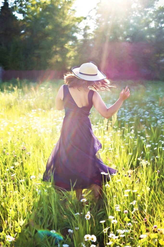 A woman walks through a field on a bright sunny day. This could represent the benefits of working with a holistic doctor in Orland Park, IL. Search for more info about holistic benefits of things like chiropractic care in Orland Park, IL today. They can offer holistic acupuncture Orland Park, IL and more. 
