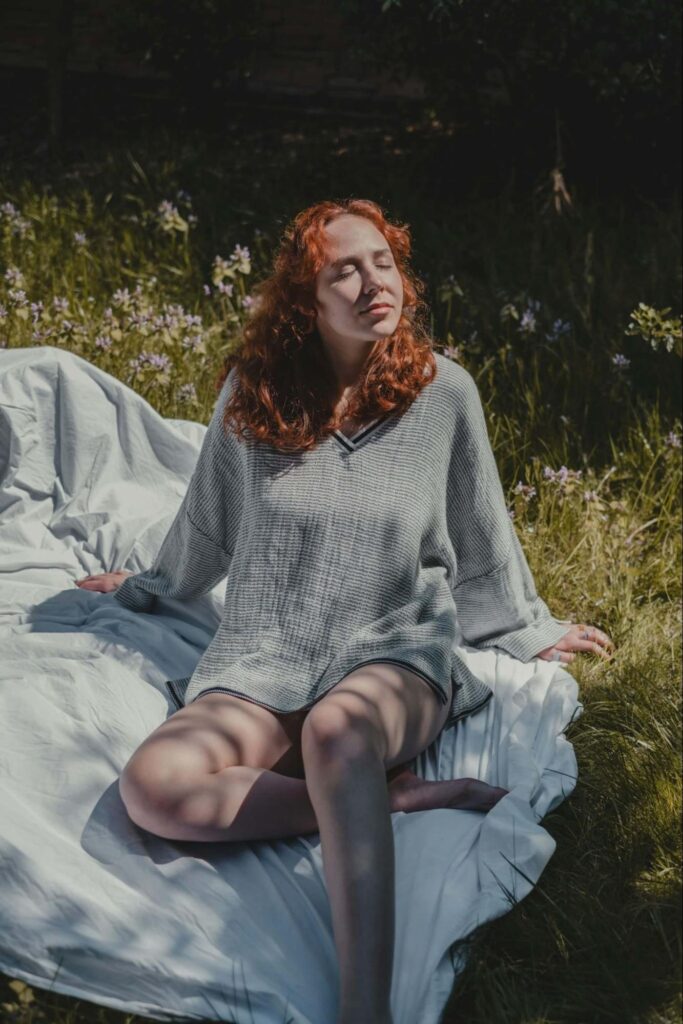 A woman sits on a picnic blanket while relaxing and taking in the sunshine. Learn how functional medicine in Orland Park, IL can help you recover from covid by searching for a holistic doctor in Orland Park, IL. They can offer support with "what is functional medicine chicago area" and more.
