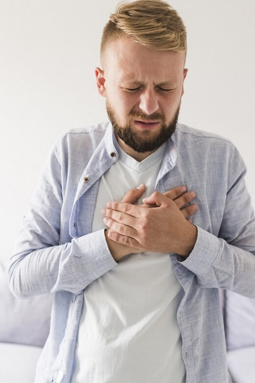 A man holds his hands over his heart with a pained expression. This could represent the pain of GERD that a holistic doctor in Orland Park, IL can help address. Learn more from an acupuncturist in Orland Park, IL and how holistic acupuncture Orland Park, IL can help today.