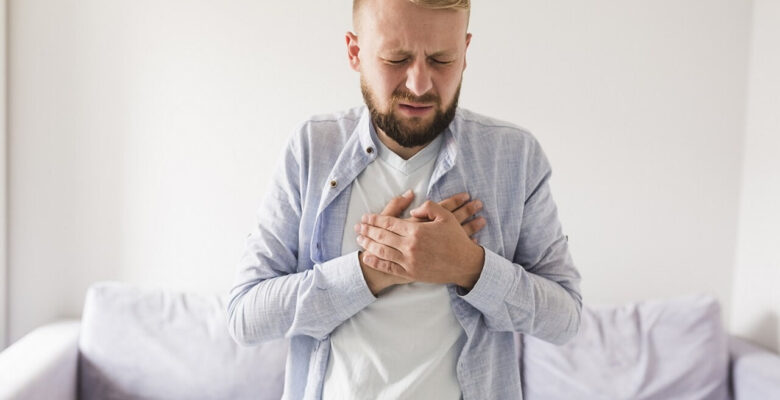 A man holds his hands over his heart with a pained expression. This could represent the pain of GERD that a holistic doctor in Orland Park, IL can help address. Learn more from an acupuncturist in Orland Park, IL and how holistic acupuncture Orland Park, IL can help today.