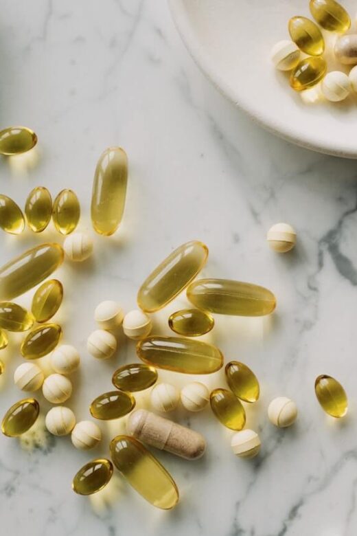 A close up of supplement pills on a marble surface. This could represent the benefits of functional medicine in Orland Park, IL in treating Long COVID symptoms. Contact a holistic doctor in Orland Park, IL to learn more about "what is functional medicine Chicago area" and how holistic medicine in the Chicago area can help today.