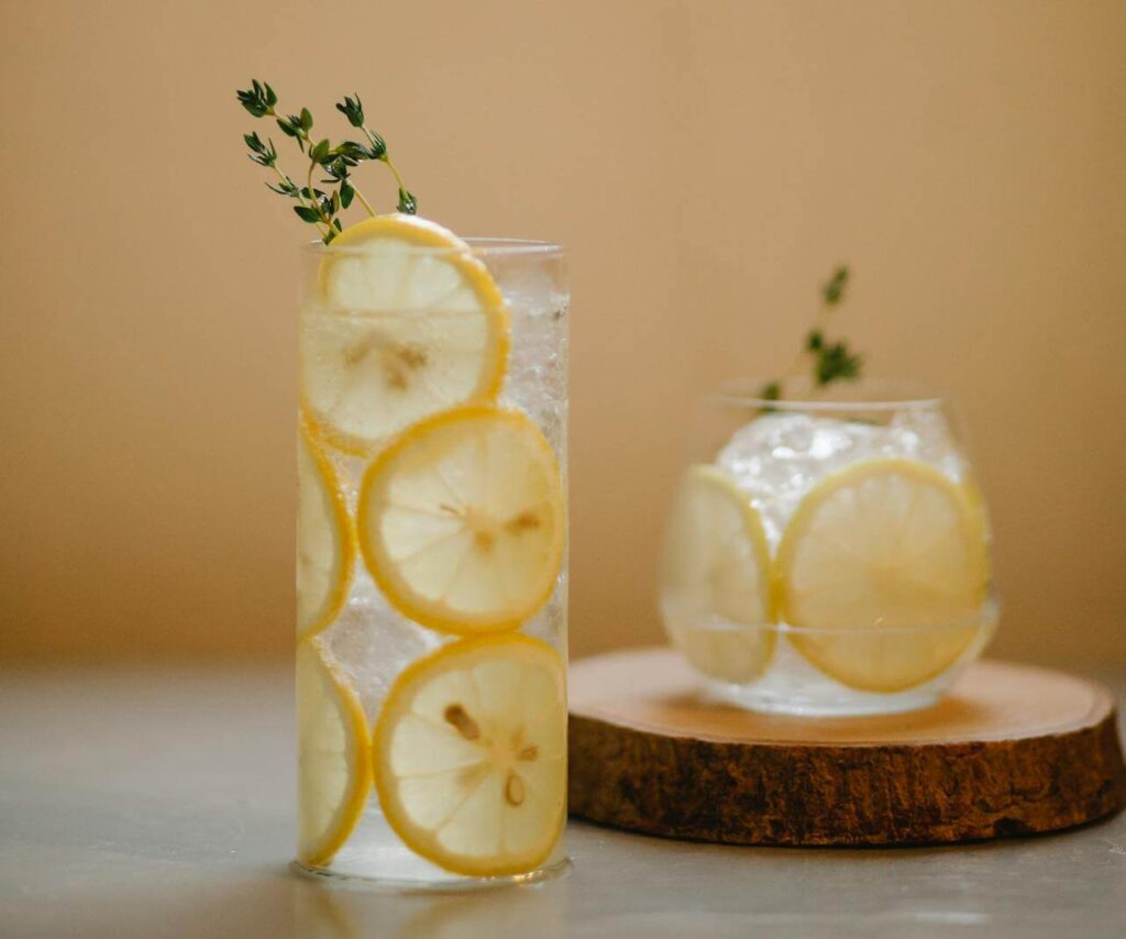 A close up of two glasses of water with ice and lemon slices. This could represent how drinking more water can help detoxification in Orland Park, IL. Learn more about how a holistic doctor in Orland Park, IL by searching for holistic medicine in the Chicago area today. 
