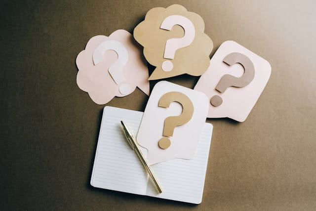 A close up of an open, blank notepad with a pen and question marks above the paper. This could represent questions that may come from the results of genetic health testing in the chicago area. Search for a holistic doctor in Chicago, IL and how genetic screening can benefit you today.
