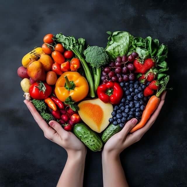 A top down view of hands holding a pile of fruits and vegetables in the shape of a heart. Learn more about genetic health testing in the Chicago area and specific foods that can support your body's nutritional needs. Search for a holistic doctor in Orland Park, IL for genetic screening in Orland Park, IL today.
