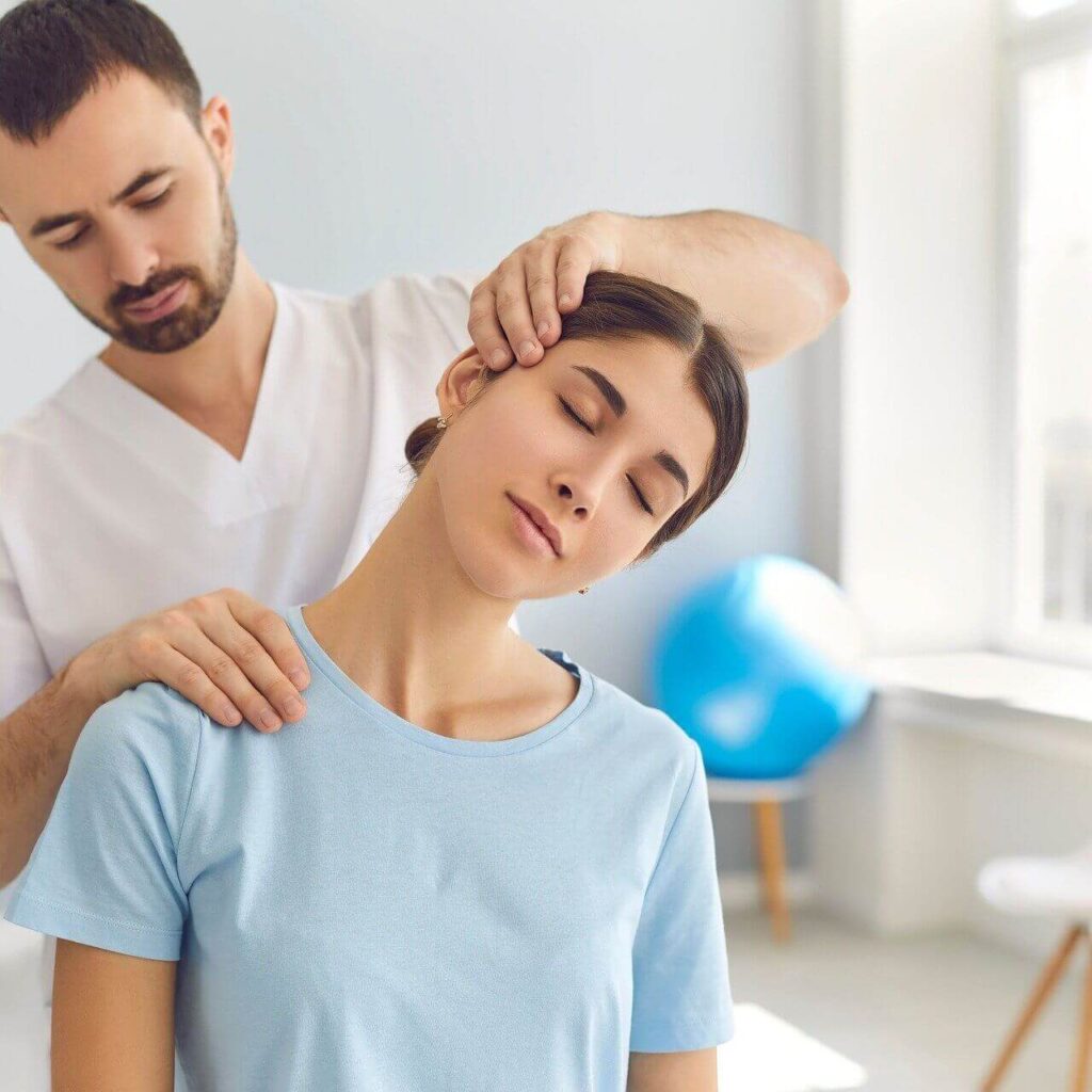 Being Adjusted | chiropractic care in orland park, il | functional medicine doctor in the chicago area | holistic chiropractor in the chicago area | holistic doctor in chicago, il | Silo Ridge | Preserve at Marley Creek | Crystal Tree Shows a chiropractor seeing how tense his pregnant patient's neck is by stretching it. Represents how a holistic chiropractor in the chicago area that provides chiropractic care in orland park, il for pregnant women can really help alleviate some symptoms from pregnancy.