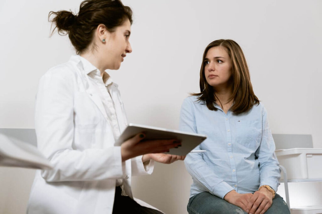 Talking to the Doctor | functional medicine doctor in the chicago area | functional medicine doctor in orland park, il | holistic doctor in chicago, il | holistic medicine in the chicago area | Preserve at Marley Creek, IL | Crystal Tree, IL | Orland Woods, IL Shows a doctor talking to a client who looks dissatisfied. Represents how functional medicine in orland park, il and working with a functional medicine doctor in the chicago area can treat you holistically.