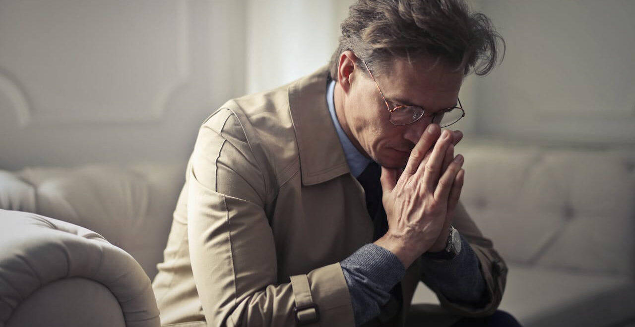 Shows a man with his face in his hands. Represents how hormone testing in Orland Park, IL with a holistic doctor in Chicago, IL can help you.