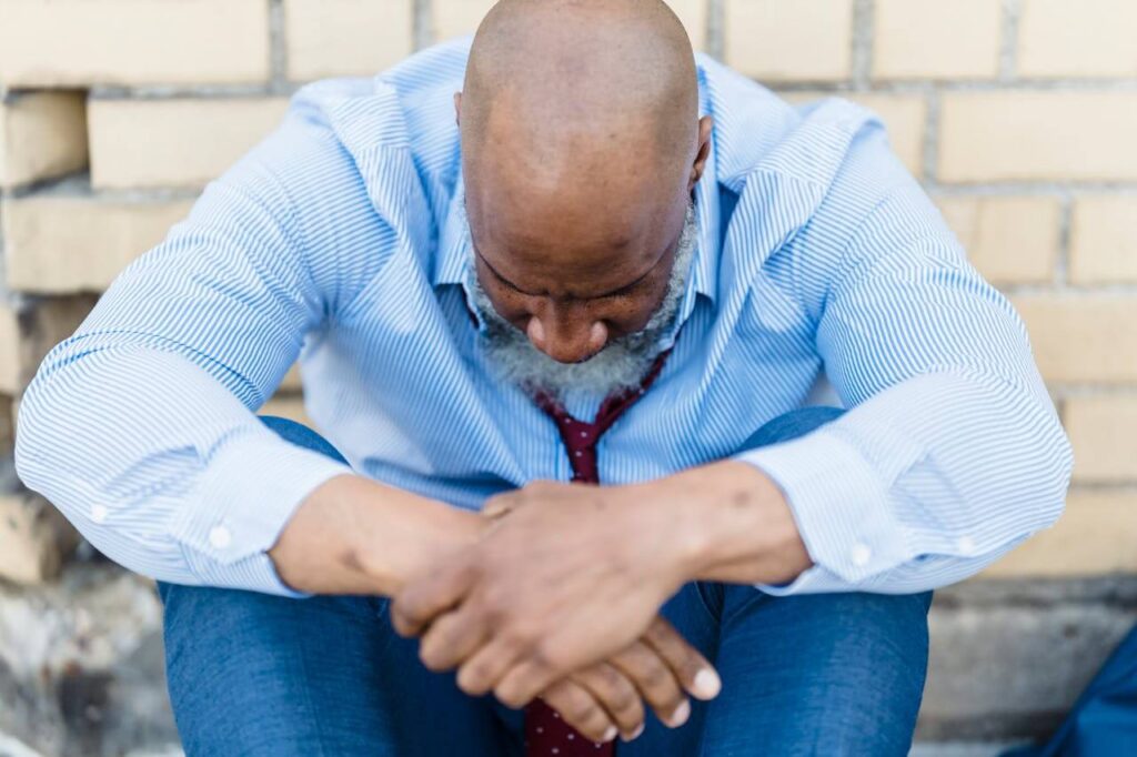 Feeling Defeated | what is functional medicine chicago area | hormone testing in orland park, il | holistic doctor in chicago, il | gut health testing orland park, il | Lincoln Park, IL | Streeterville, IL | Preserve at Marley Creek, IL Shows a man looking down in defeat. Represents how a functional medicine doctor in the chicago area can answer what what is functional medicine chicago area can do for you.