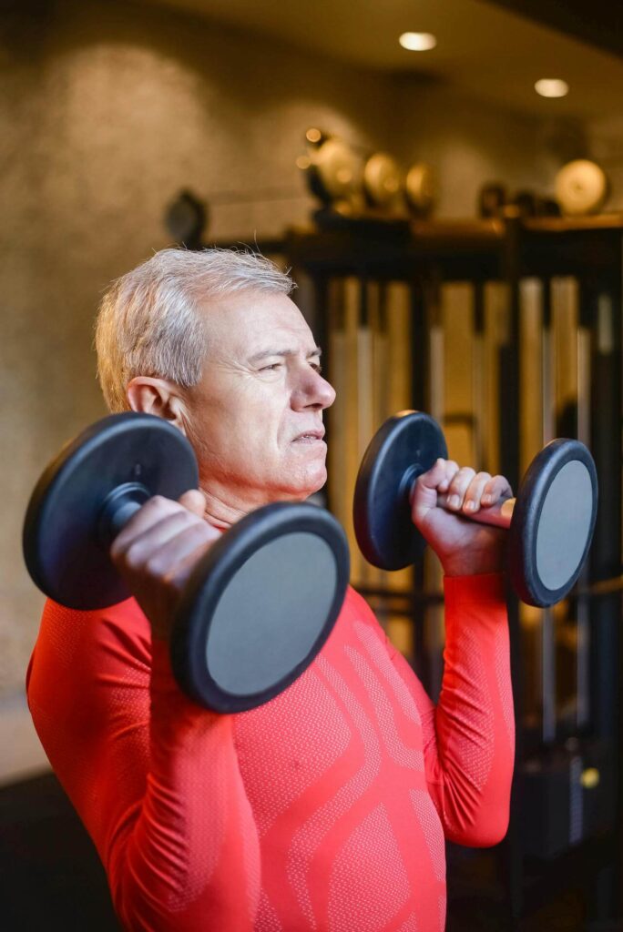 Lifting Weights | functional medicine doctor in the chicago area | functional medicine doctor in orland park, il | gut health testing orland park, il | holistic doctor in chicago, il | West Loop, IL | Old Town, IL | Orland Park Crossing, IL Shows a man lifting weights to maintain his health. Represents how you can use hormone testing in Orland Park, IL and functional medicine doctor in the chicago area can help your health.
