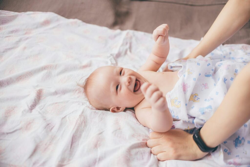 Shows a smiling baby looking up. Represents how a holistic chiropractor in the chicago area with chiropractic care in orland park, il can support the pediatric population.