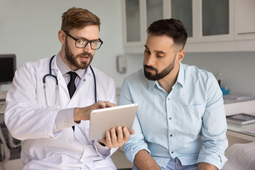 Male doctor explaining normal lab results to a male patient. Feel better with functional Medicine in Orland Park, IL.