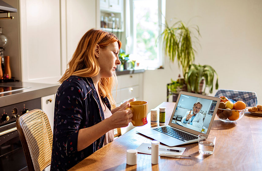 Woman holding mug during a functional medicine consultation discussing health symptoms in Orland Park, IL.