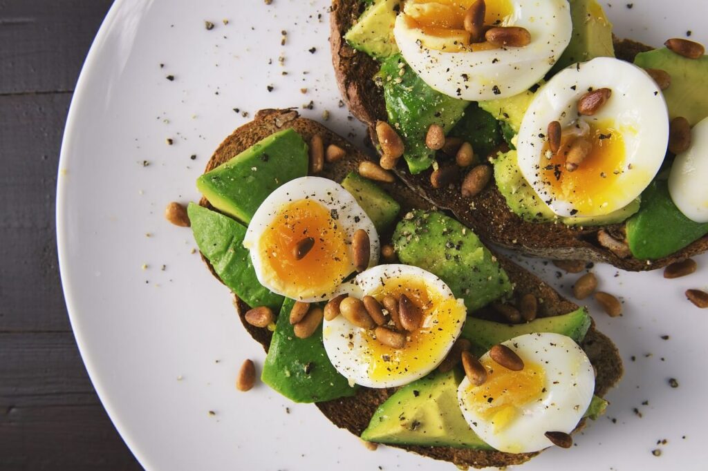 Plate with toast, avocado, and boiled eggs. Struggling with burnout? Functional medicine in Orland Park, IL offers a personalized path to healing.