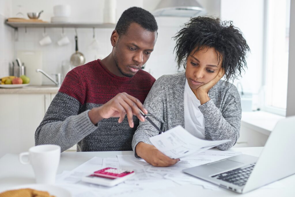 Man and woman sitting in front of the computer doing bills together and learning about the Good Faith Estimate in Orland Park, IL.