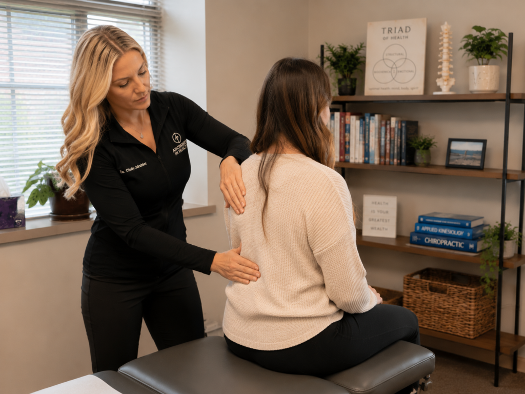 Female chiropractor performing an examination on a patient in Orland Park, IL.